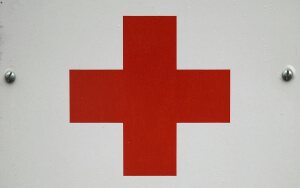 A picture taken on May 31, 2015 shows a plaque at the headquarters of French Red Cross in Paris. Reacting to a May 31 article in the French daily Le Parisien, the French Red Cross said in a communique that it had not paid its employees overtime, explaining the situation was tied to its mission of "saving lives".  AFP PHOTO / STEPHANE DE SAKUTIN        (Photo credit should read STEPHANE DE SAKUTIN/AFP/Getty Images)